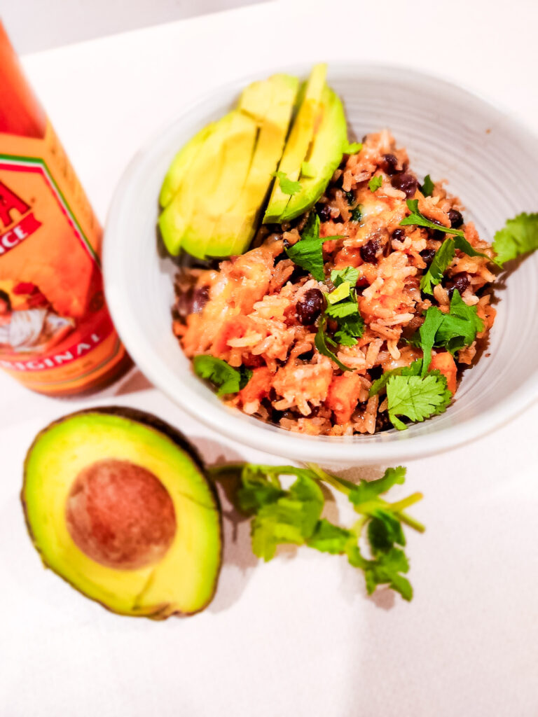 southwest sweet potato black bean & rice skillet topped with avocado