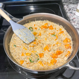 Tuscan butter squash orzo in a stainless steel sliller