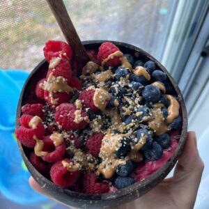 Hawaiian style acai bowl in a coconut bowl