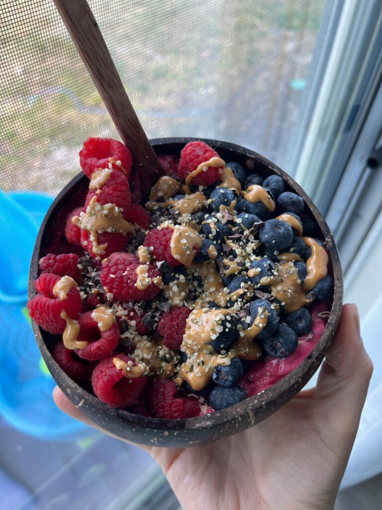 Hawaiian style acai bowl in a coconut bowl