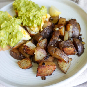 breakfast potatoes and avocado toast topped with breakfast seasoning