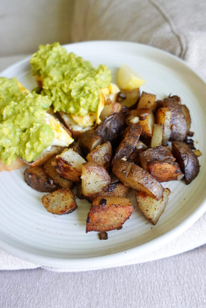 breakfast potatoes and avocado toast topped with breakfast seasoning